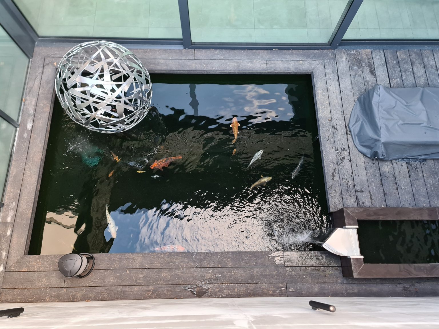 Koi pond with integrated circulation and surrounding deck