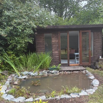 Restored wildlife pond with natural stone edging and wildlife planting in Bovey Tracey.