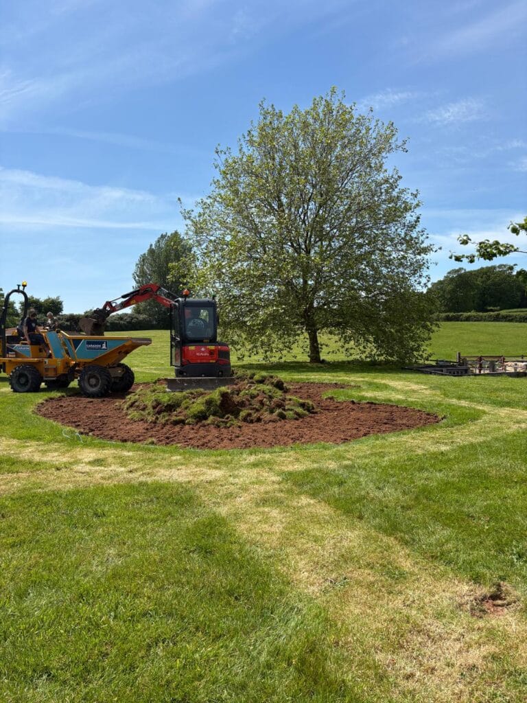 Mini excavator and site dumper shaping a wildlife pond during construction