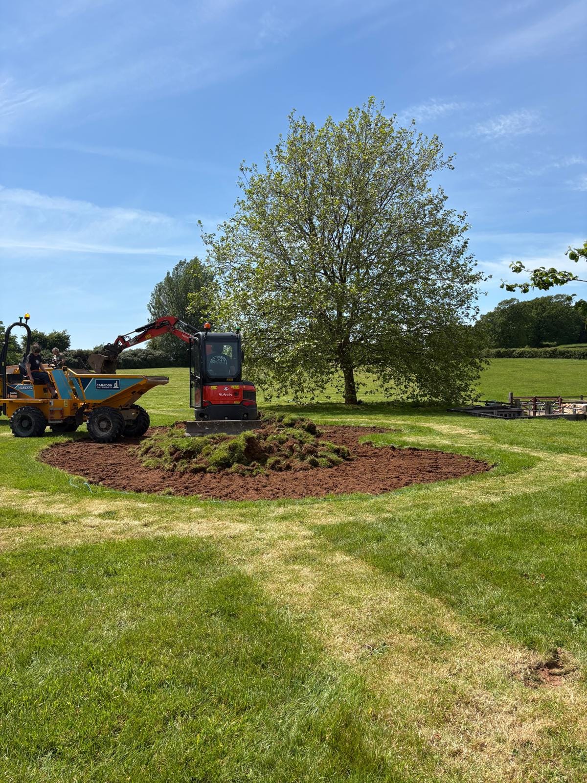 Mini excavator and site dumper shaping a new wildlife pond