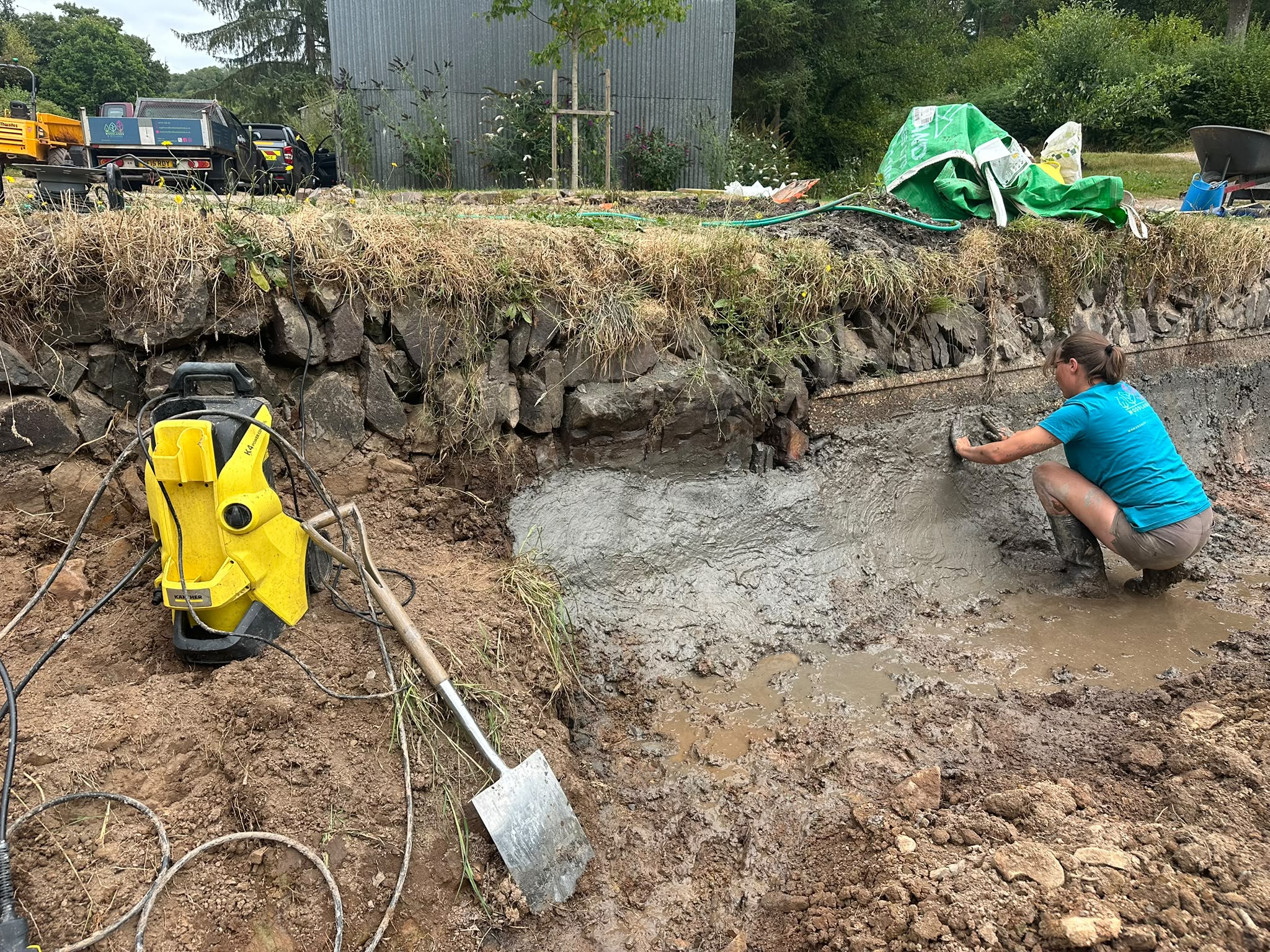 Repairing the historic pond wall after silt removal exposed damaged masonry
